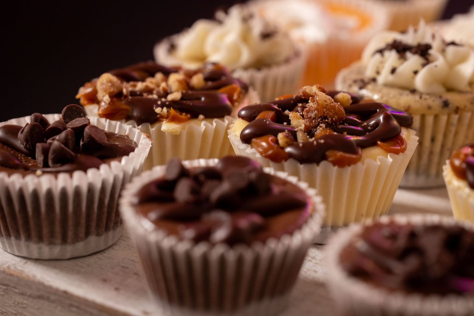 Assorted mini cheesecakes with chocolate drizzle, caramel, and toffee crumble toppings by The Cheesecake Lady Deb Shultis, Southern Illinois wedding dessert vendor